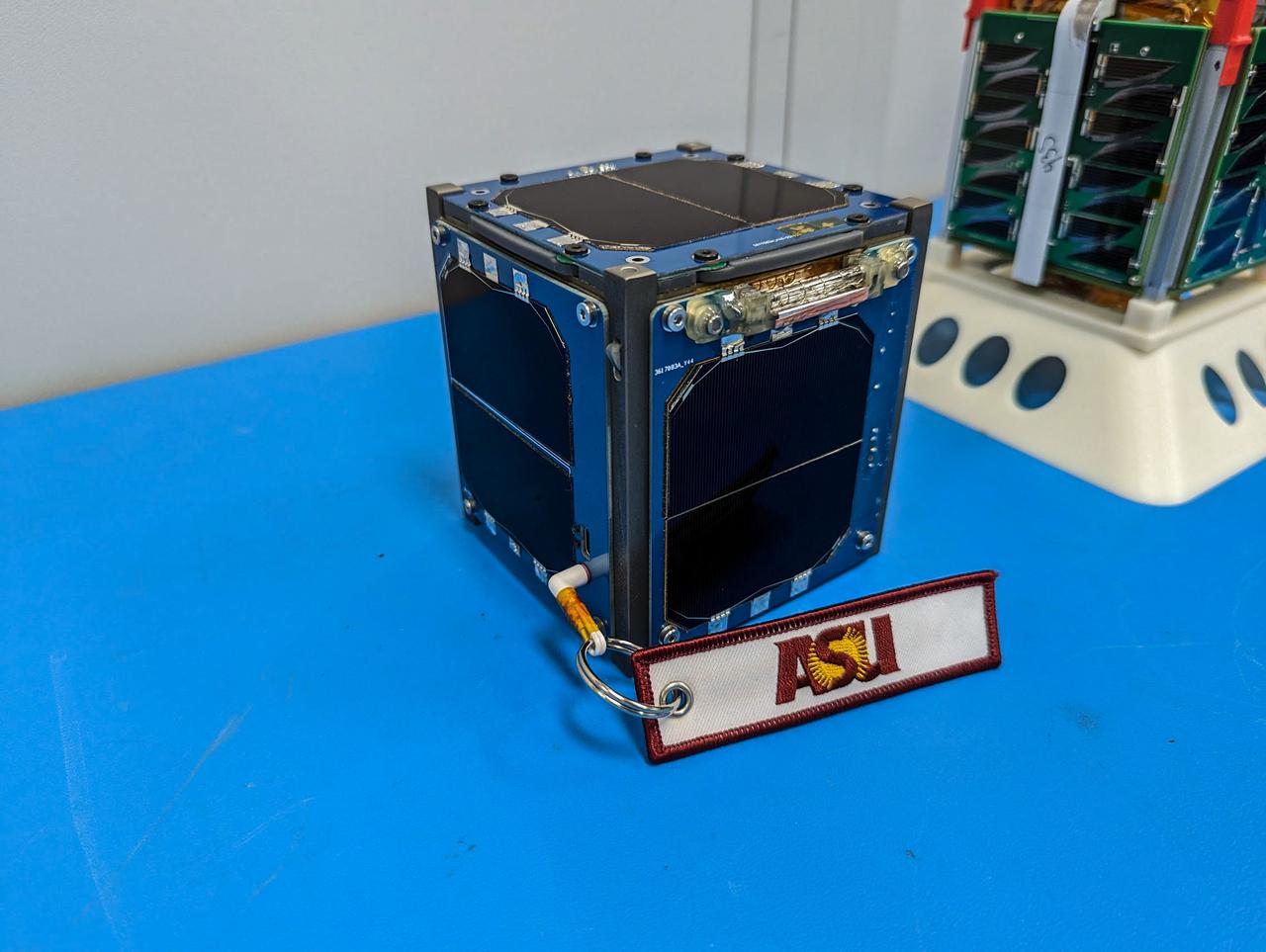 jsc2023e010191 (12/13/2022) --- LightCube CubeSat (foreground) and ARKSat-1 (background) await integration. Image courtesy of Jaime Sanchez de la Vega.