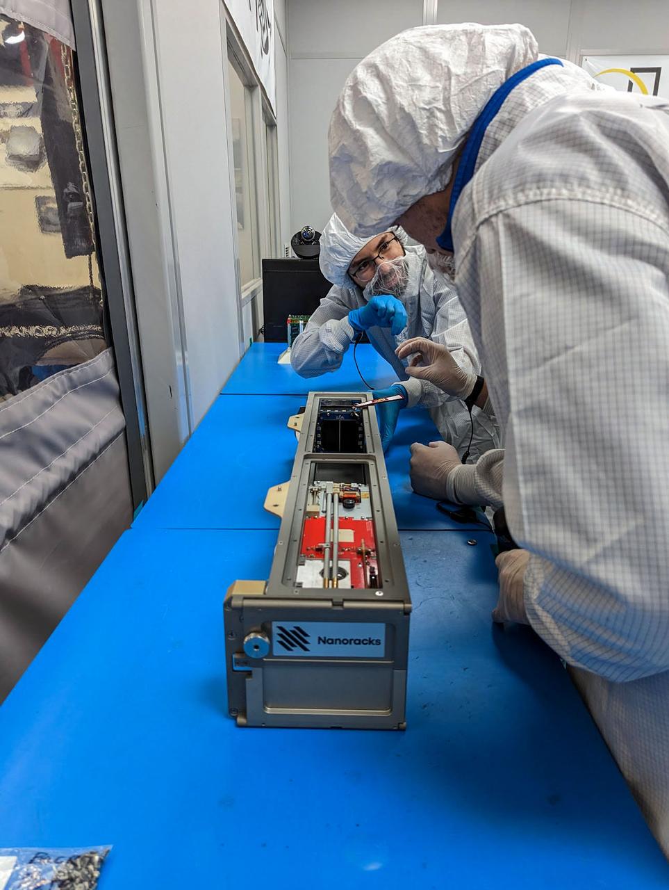 jsc2023e010193 (12/13/2022) --- The LightCube CubeSat is inserted into the Nanoracks CubeSat Deployer by Jaime Sanchez de la Vega and Nanoracks personnel. Image courtesy of Jaime Sanchez de la Vega.