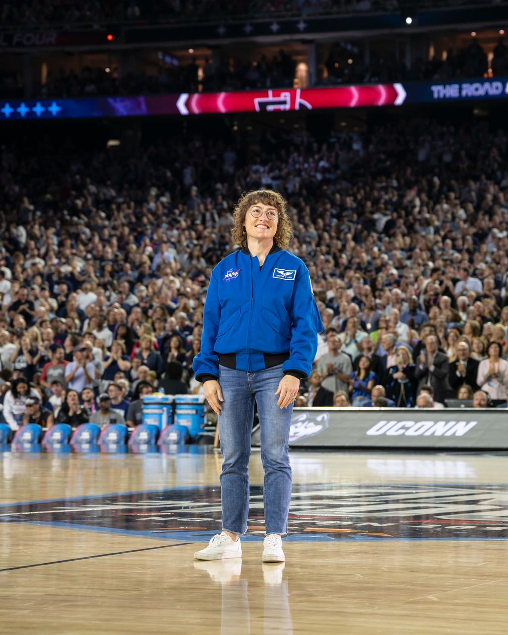jsc2023e018315 (April 3, 2023) – NASA astronaut Artemis II Mission Specialist Christina Koch is introduced on the basketball court while attending the NCAA Men’s Final Four national championship game at NRG Stadium in Houston. The crew is comprised of Commander Reid Wiseman, Pilot Victor Glover, and Mission Specialists Christina Koch and Jeremy Hansen. The four astronauts will venture around the Moon on Artemis II, the first crewed mission on NASA’s path to establishing a long-term presence at the Moon for science and exploration through Artemis.
