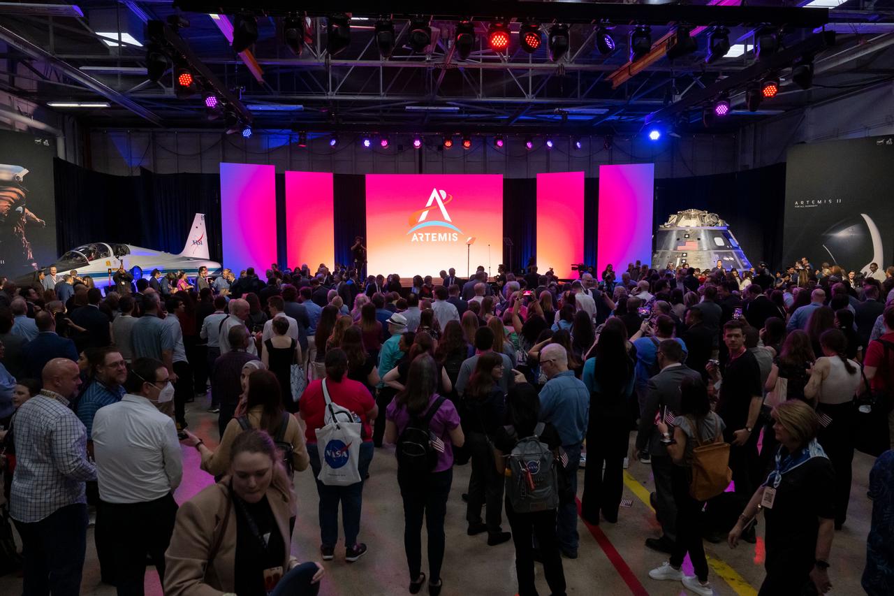 jsc2023e018434 (April 3, 2023) – The audience awaits the announcement of the Artemis II crew during a Monday, April 3, 2023, news conference at Ellington Field near NASA’s Johnson Space Center in Houston. The crew is comprised of Commander Reid Wiseman, Pilot Victor Glover, and Mission Specialists Christina Koch and Jeremy Hansen. The four astronauts will venture around the Moon on Artemis II, the first crewed mission on NASA’s path to establishing a long-term presence at the Moon for science and exploration through Artemis.