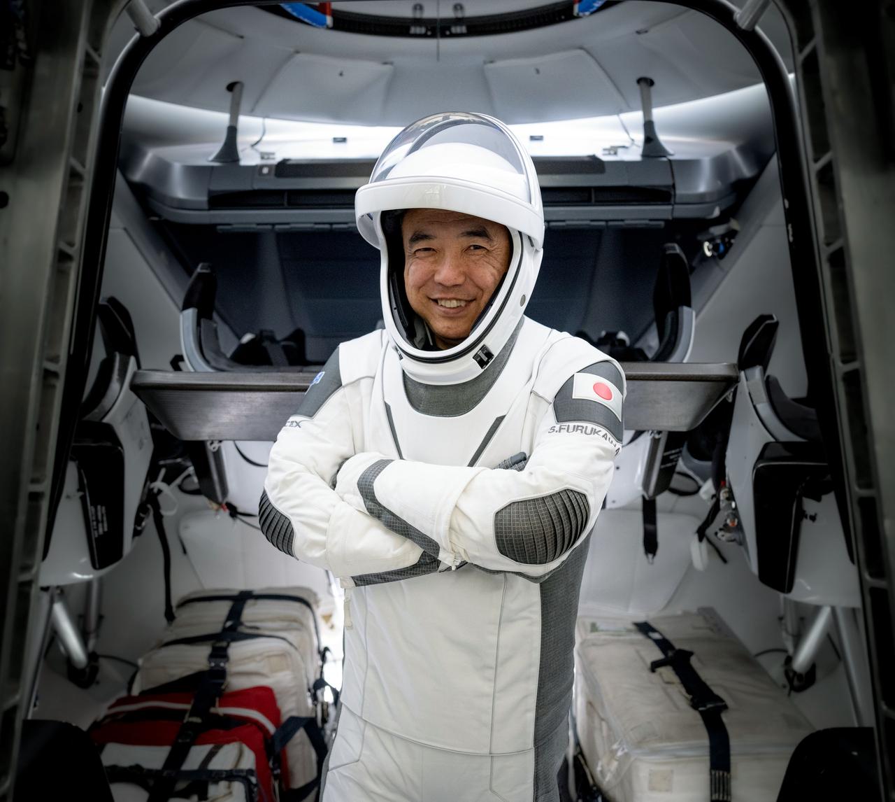 jsc2023e045335 - JAXA astronaut Satoshi Furukawa, mission specialist of NASA's SpaceX Crew-7 mission, poses for a photo in his pressure suit during a crew equipment integration test at SpaceX headquarters in Hawthorne, California. Credit: SpaceX 
