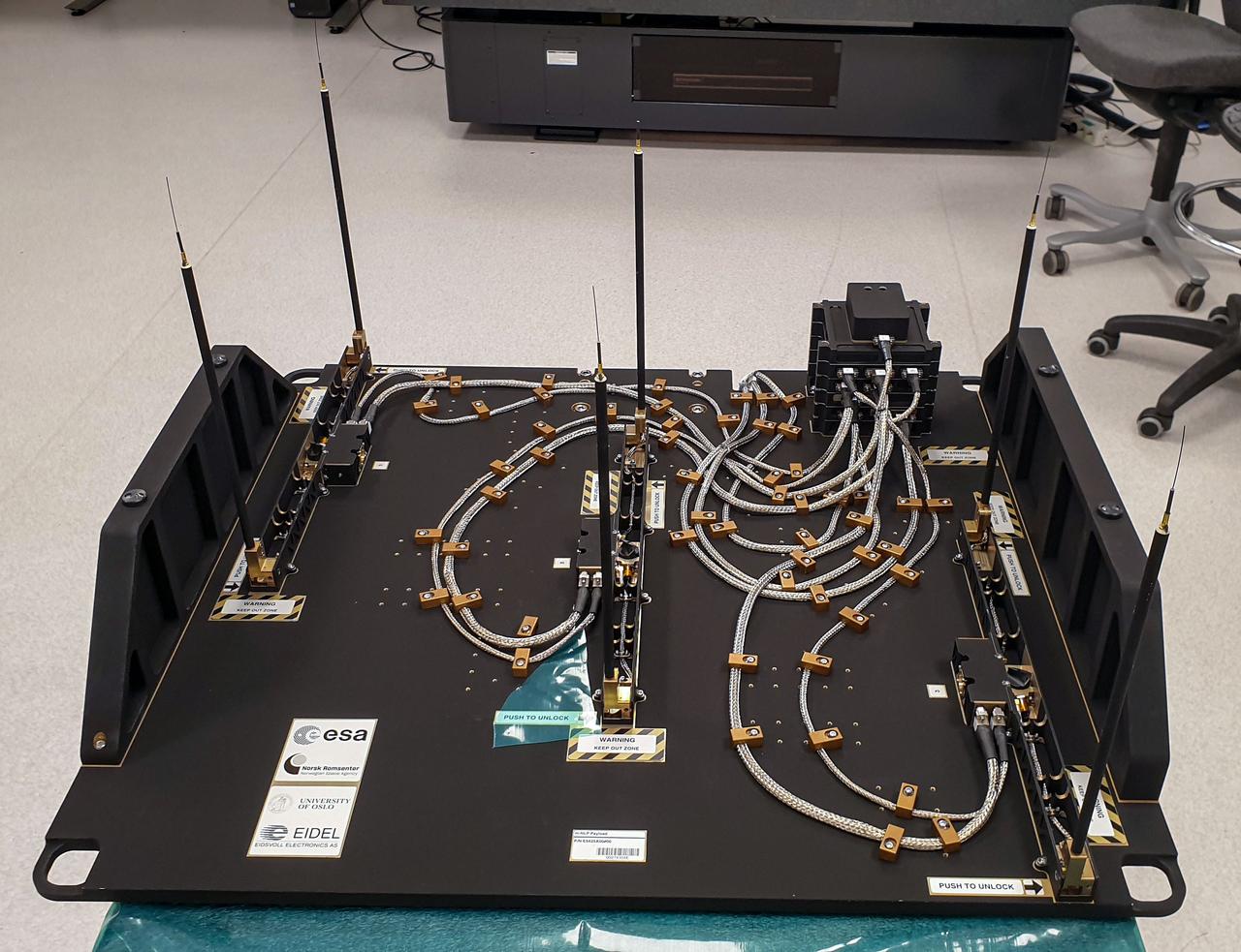 jsc2023e046372 (9/30/2022) --- The Multi-Needle Langmuir Probe (m-NLP) is shown from the ram facing side with booms in deployed position. The m-NLP measures plasma density in the ionosphere, where Earth's atmosphere meets the beginning of space. Researchers aim to study electrically charged particles and increase their understanding of how particle phenomena affect radio communications and global navigation satellite system (GNSS) signals. Image courtesy of the University of Oslo, Espen Trondsen.