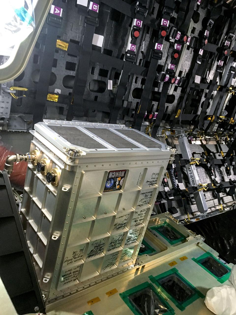 jsc2023e046376 (12/12/2019) --- The Far-Field Diagnostic (FFD) hardware for Spacecraft Fire Experiment-VI (Saffire-VI) is pictured aboard Cygnus before launch. This package contains the Smoke Eater and CO scrubbers, a prototype Combustion Product Monitor to be used on Orion, particulate sensors, and sensors for CO, CO2, and oxygen gases. The containers for the FFD were fabricated by HUNCH (High school students United with NASA to Create Hardware). Their signatures are shown on the side of the FFD. The Saffire series helps researchers to understand realistic fire spread scenarios on spacecraft and generate advanced protective equipment.