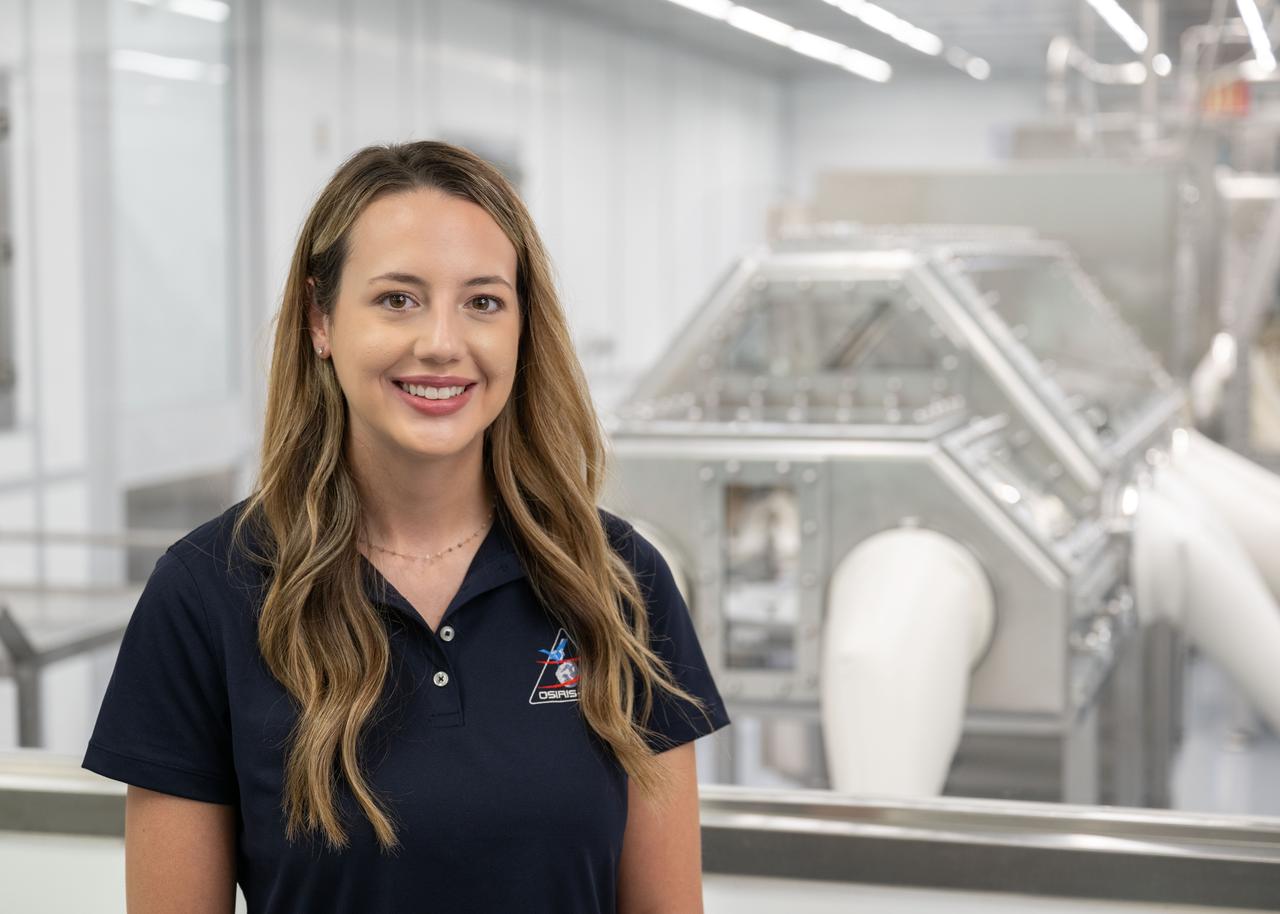 Portrait of Julia Plummer, OSIRIS-REx astromaterials processor from the Astromaterials Research and Exploration Science (ARES) division at NASA's Johnson Space Center in Houston. Plummer is seen in front of the OSIRIS-REx cleanroom at Johnson. Credit: NASA/James Blair 