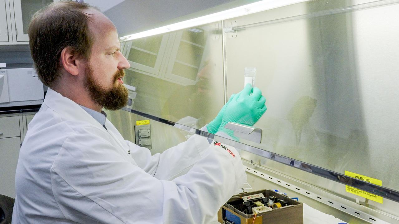 jsc2023e052854 (9/6/2023) --- Dr. Aaron Rodgers unboxes the BFF-Meniscus-2 investigation after its return from the International Space Station. The first human knee meniscus has been successfully 3D bioprinted in orbit using the BioFabrication Facility. This is a significant step towards developing solutions to promote recovery from musculoskeletal injuries. Image courtesy of Redwire.