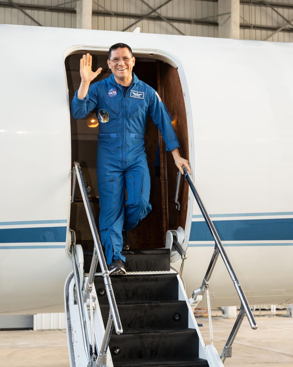 jsc2023e054871 (Sept. 28, 2023) --- NASA astronaut Frank Rubio waves after returning to Ellington Field in Houston, Texas, aboard a NASA jet following the completion of his 371-day mission aboard the International Space Station.