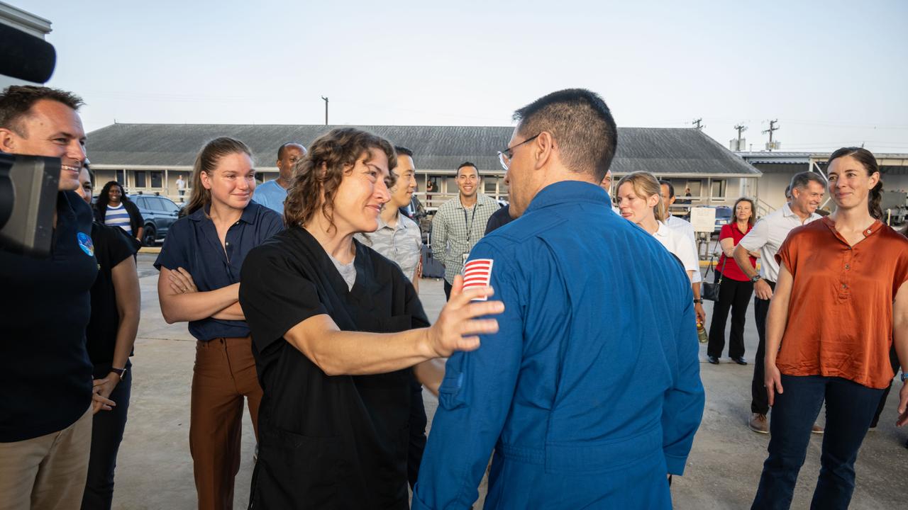 jsc2023e054876 (Sept. 28, 2023) --- NASA astronaut Frank Rubio is greeted by coworkers, including fellow NASA astronaut Christina Koch (center), following his arrival at Ellington Field in Houston, Texas, aboard a NASA jet. Rubio had just completed a 371-day mission aboard the International Space Station the day before.