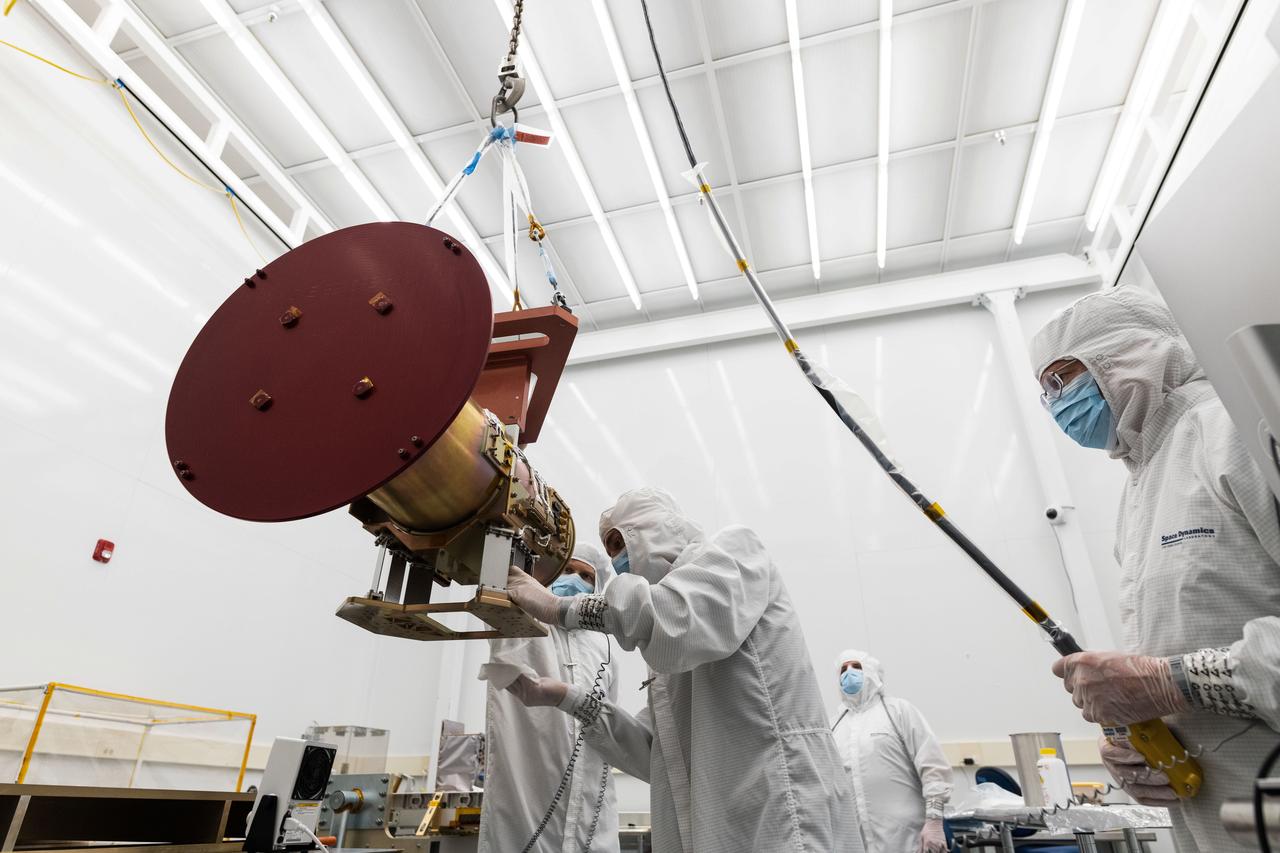jsc2023e055879 (11/9/2022) --- Space Dynamics Laboratory (SDL) employees ensure the Opto-Mechanical Assembly interface to the flight EXPRESS Payload Adapter is clean before mounting. The Atmospheric Waves Experiment (AWE) examines the global distribution of small-scale atmospheric gravity waves (AGWs) and how they move through the upper atmosphere, vary with season and geographic location, and contribute to space weather. Image courtesy of SDL/Allison Bills.