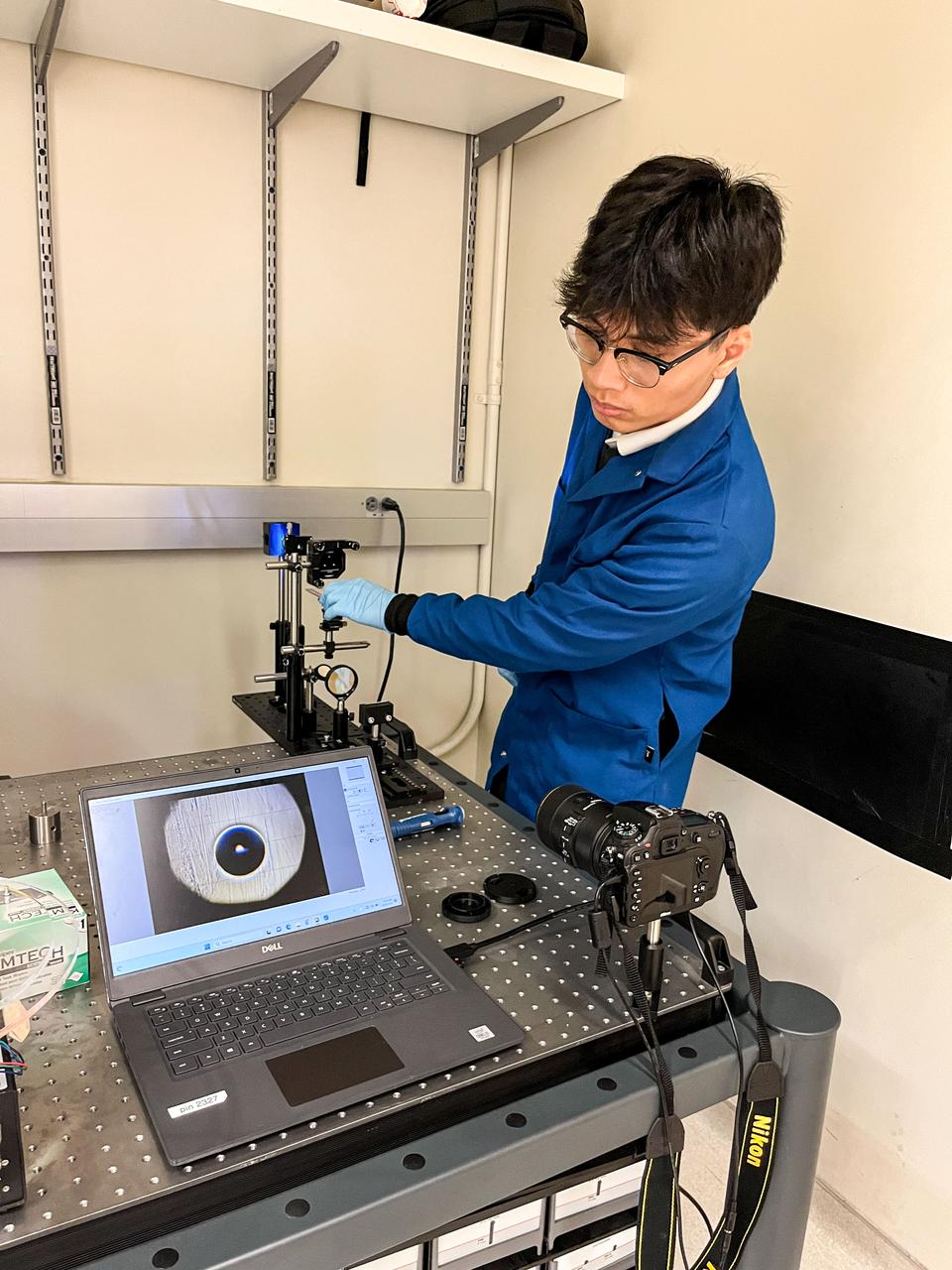 jsc2023e055884 (9/26/2023) --- Trinh Huynh uses a quantitative Schlieren system to measure the deformation of the mucus-like gel around a liquid drop. The Gaucho Lung investigation will study fluid transport within gel-coated tubes to learn more about treatment programs for respiratory distress syndrome and develop new contamination control strategies. Image courtesy of University of California, Santa Barbara.