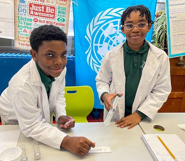 jsc2023e065183 (1/13/2023) --- Rundell Swan and Tristan Cole work on their experiment, What are the effects of microgravity on the germination of raphanus sativus (radish seeds), which will be included in the Nanoracks-National Center for Earth and Space Science Education-Orbiter-Student Spaceflight Experiments Program Mission 17 to ISS (Nanoracks-NCESSE-Orbiter-SSEP).