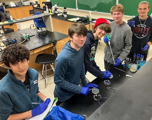 jsc2023e065187 (2/6/2023) --- Student researchers work on their experiment, which will be included in the Nanoracks-National Center for Earth and Space Science Education-Orbiter-Student Spaceflight Experiments Program Mission 17 to ISS (Nanoracks-NCESSE-Orbiter-SSEP). Pictured left to right: Evan Hernandez, Georgi Shourmaroff, Evan Boyer, Bryan Nash, and Kagan Holder.