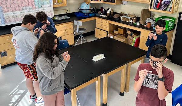 jsc2023e065202 (10/19/2023) --- Student researchers work on their experiment, How Does Microgravity Affect the Germination of Oyster Mushroom Spawns (Pleurotus Ostreatus), which will be included in the Nanoracks-National Center for Earth and Space Science Education-Orbiter-Student Spaceflight Experiments Program Mission 17 to ISS (Nanoracks-NCESSE-Orbiter-SSEP).