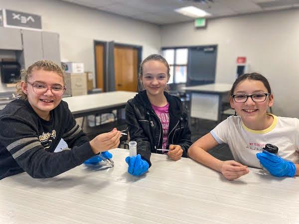 jsc2023e065210 (1/24/2023) --- Fifth grade students from Pendergast School District work on their experiment, which will be included in the Nanoracks-National Center for Earth and Space Science Education-Orbiter-Student Spaceflight Experiments Program Mission 17 to ISS (Nanoracks-NCESSE-Orbiter-SSEP). Pictured left to right: Brynn Smith, Sophia Ketring, and Zoey Harrold.