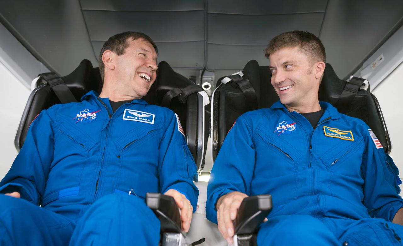 jsc2023e066244 (Oct. 15, 2023) --- NASA astronauts (from left) Michael Barratt and Matthew Dominick, SpaceX Crew-8 Pilot Specialist and Commander respectively, participate in preflight mission training inside a Dragon mockup crew vehicle at SpaceX headquarters in Hawthorne, California. Credit: SpaceX