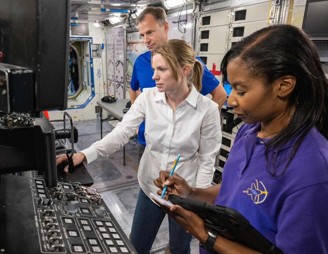 jsc2023e066272 (Oct. 24, 2023) --- (From left) NASA astronauts Nick Hague, Zena Cardman, and Stephanie Wilson train at the Space Vehicle Mockup Facility at NASA's Johnson Space Center in Houston, Texas, for the SpaceX Crew-9 mission to the International Space Station. Credit: NASA/James Blair