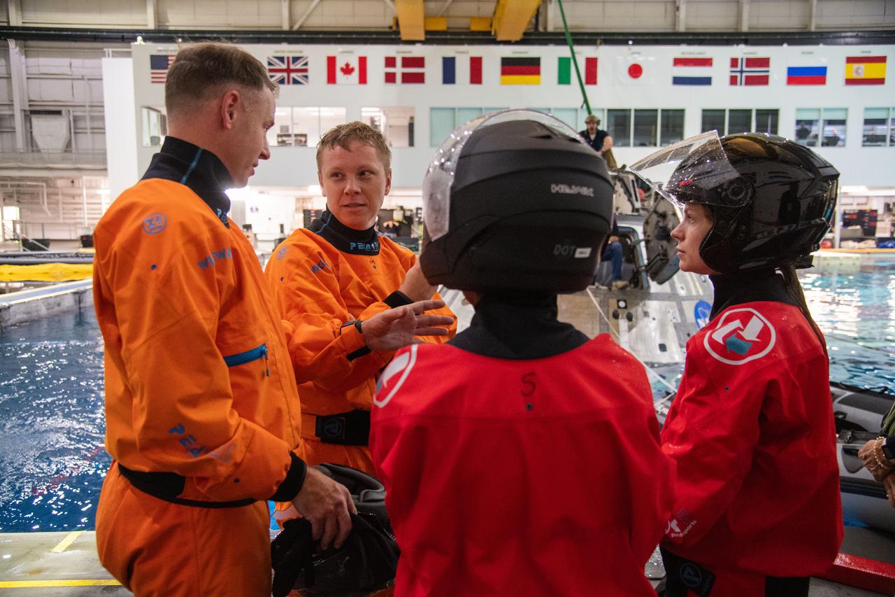 jsc2023e071476 (Nov. 3, 2023) --- (From left) NASA astronaut Nick Hague, Roscosmos cosmonaut Aleksandr Gorbunov, and NASA astronauts Stephanie Wilson and Zena Cardman participate in crew water survival training at the Neutral Buoyancy Laboratory at NASA's Johnson Space Center in Houston, Texas, for the SpaceX Crew-9 mission to the International Space Station. Credit: Robert Markowitz
