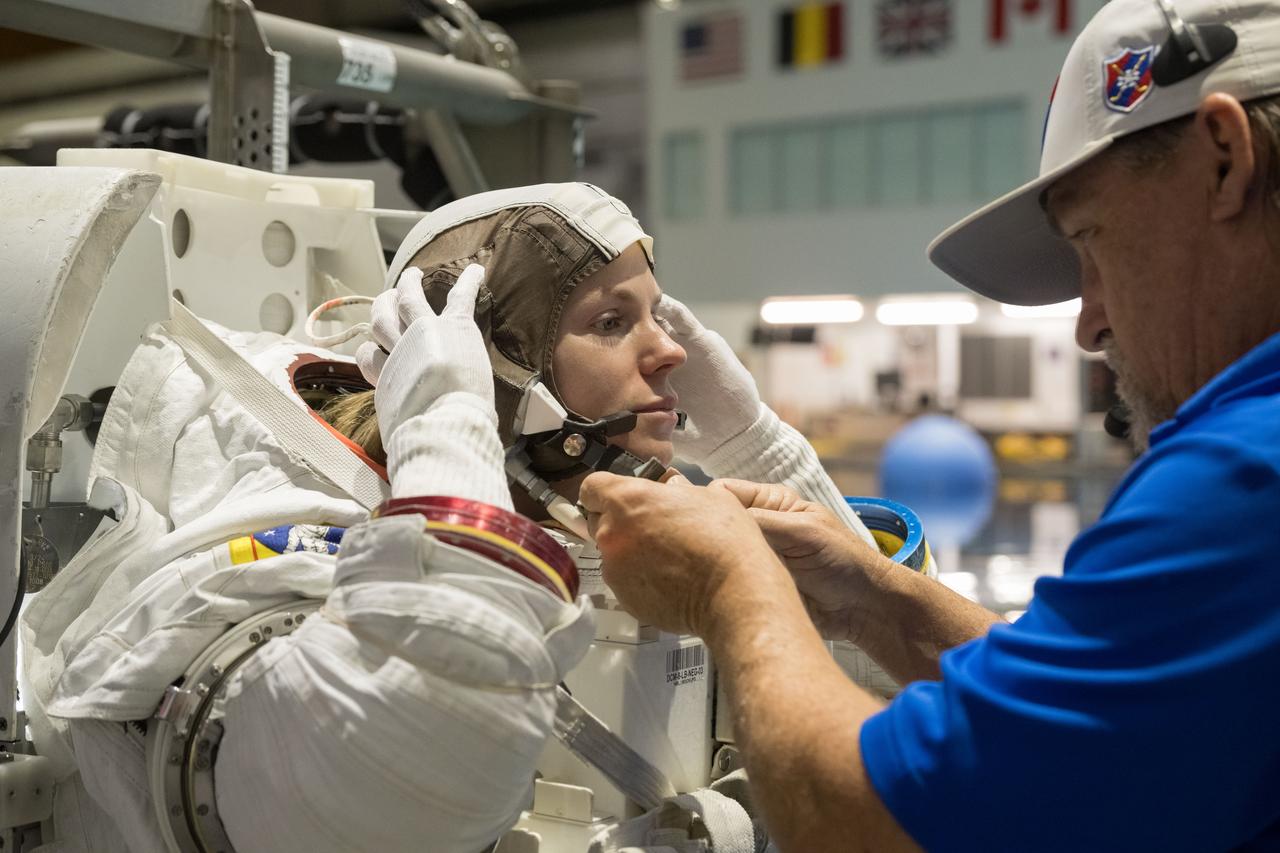 jsc2023e071559 (Nov. 6, 2023) --- NASA astronaut Zena Cardman, assisted by a technician, trains for a spacewalk at the Neutral Buoyancy Laboratory at NASA's Johnson Space Center in Houston, Texas, for the SpaceX Crew-9 mission to the International Space Station. Credit: NASA/Bill Stafford
