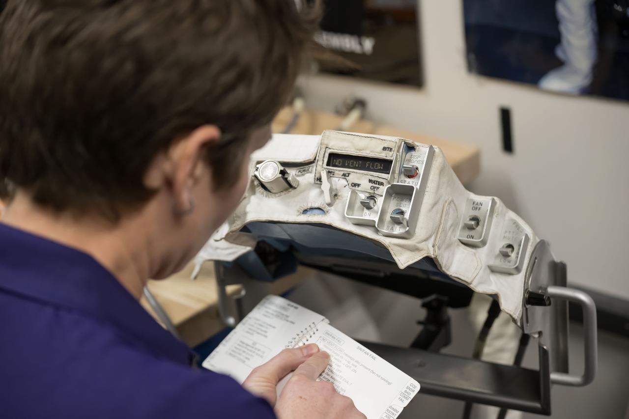 jsc2023e080989 (Dec. 18, 2023) --- NASA astronaut and SpaceX Crew-10 Commander Anne McClain reviews procedures during pre-flight mission training at NASA's Johnson Space Center.