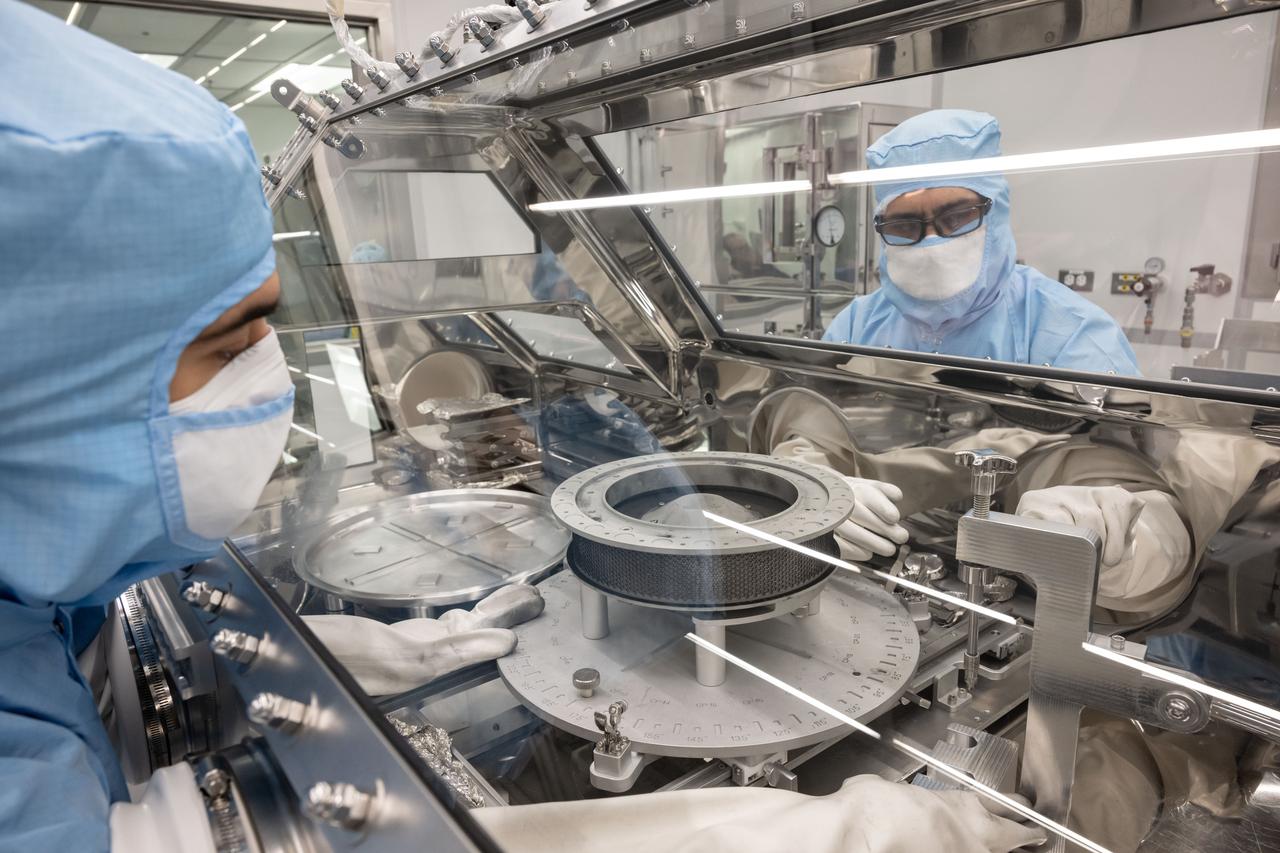 OSIRIS REx curation team attempting to remove the two stuck fasteners that are currently prohibiting the complete opening of the TAGSAM head. Photo Date: January 10, 2024. Location: Bldg. 31 - 2nd Floor - OSIRIS-REx lab. Photographer: Robert Markowitz
