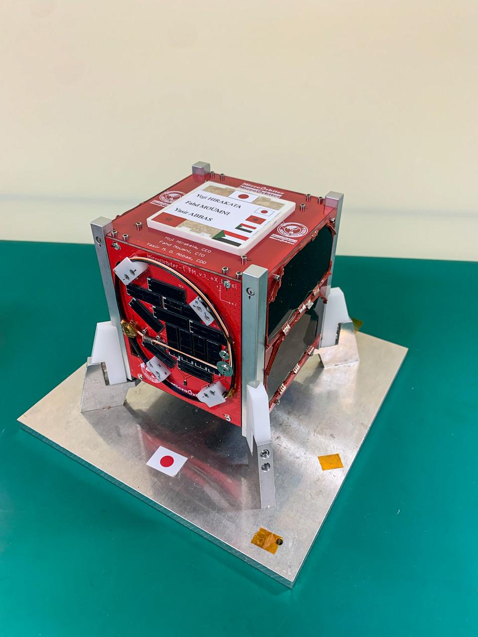 jsc2024e006083 (1/19/2024) --- The MicroOrbiter-1 Flight Model is placed on a metallic stand. ..Image Credit: MOUMNI Fahd.