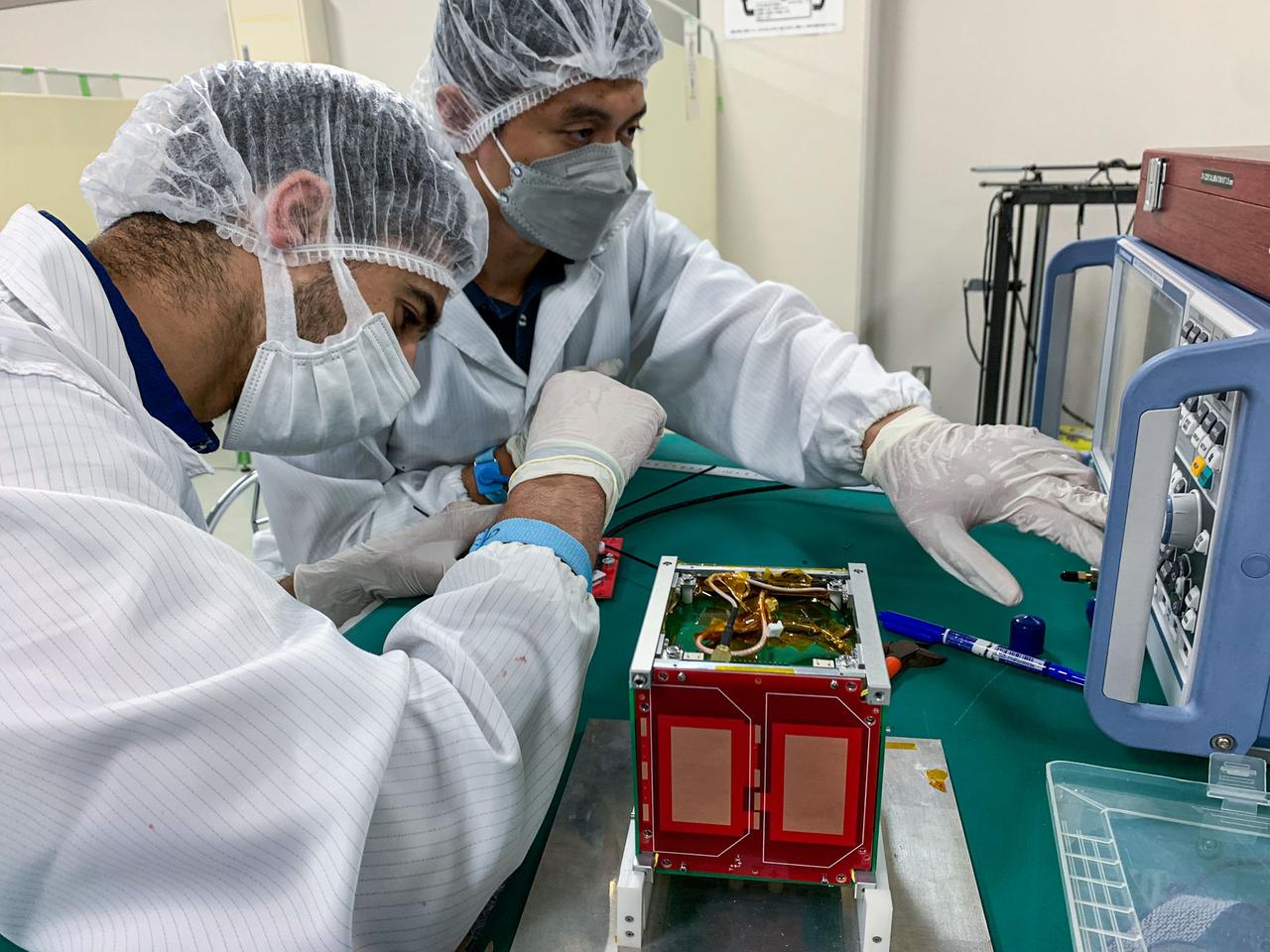 jsc2024e006084 (7/13/2022) --- The dipole antennas are being tuned using a spectrum analyzer in the clean room. From left to right : MOUMNI Fahd, ALMONTE John-Paul..Image Credit: MOUMNI Fahd.