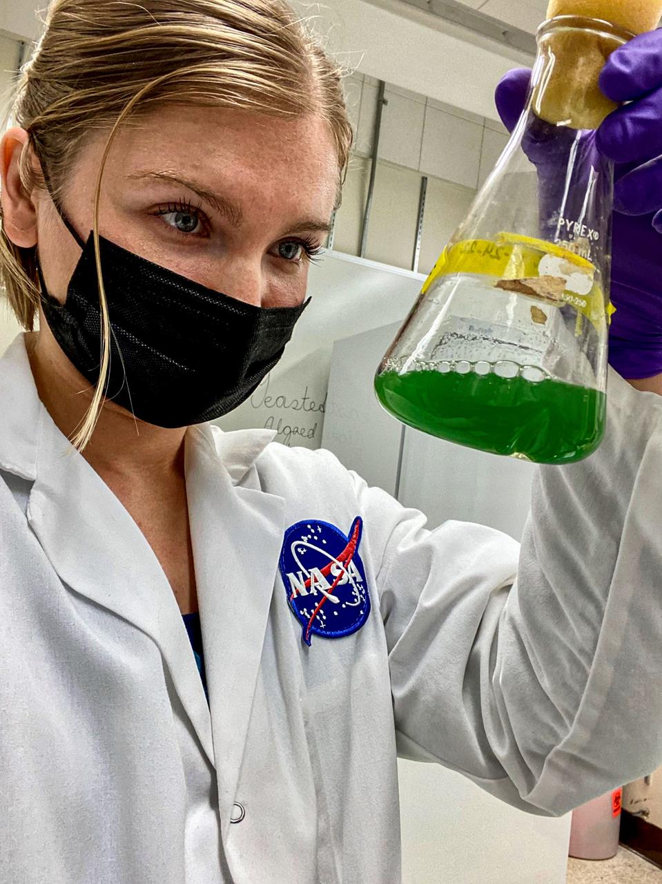 jsc2024e006098 (1/18/2024) --- A NASA ARC researcher, Katherine Fisher with A. Platensis in a culture flask. Image courtesy of Katherine Fisher