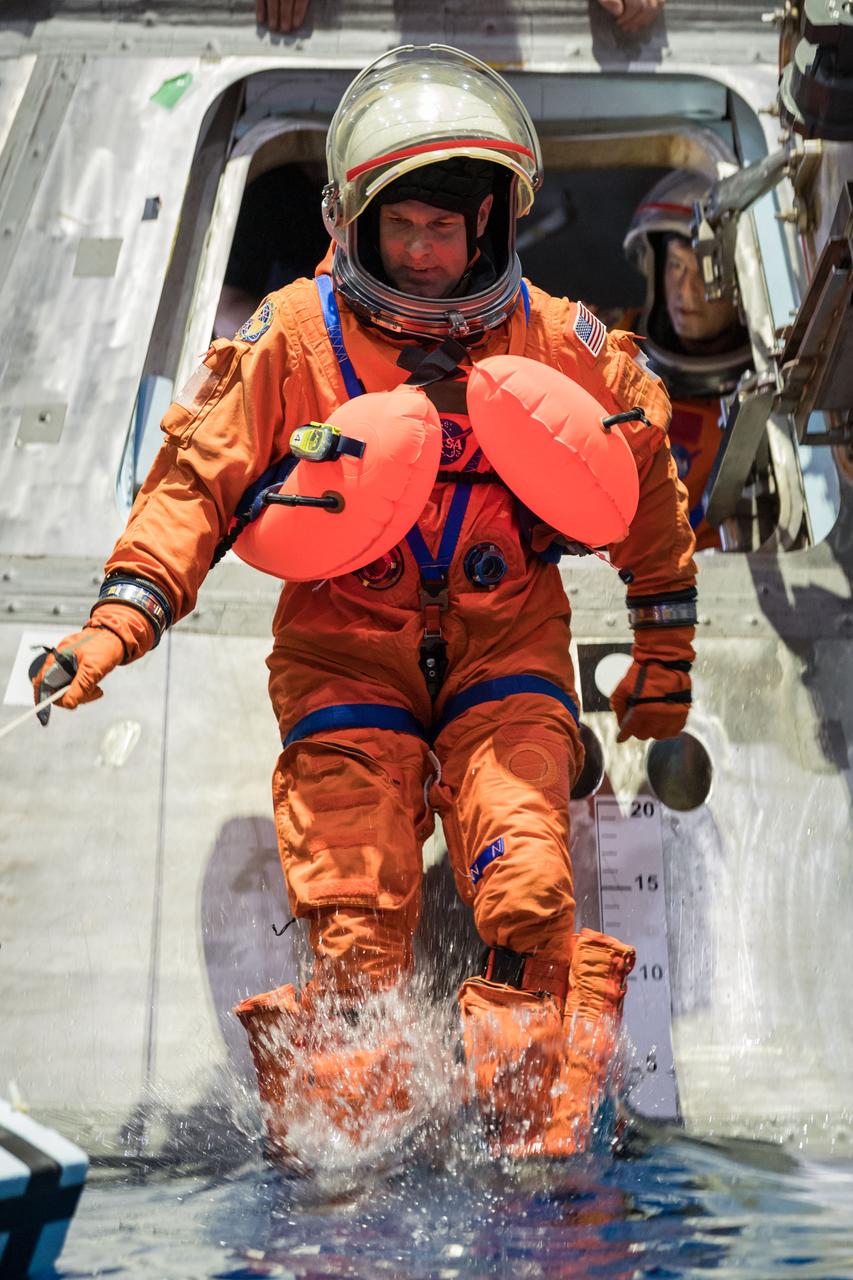 jsc2024e009647 (Jan. 23, 2024) --- Artemis II crew member and Canadian Space Agency astronaut Jeremy Hansen exits a mockup of the Orion spacecraft during a training exercise in the Neutral Buoyance Lab at NASA’s Johnson Space Center in Houston, January 23. The crew practiced exiting the spacecraft in a variety of scenarios in preparation for the mission around the Moon next year.