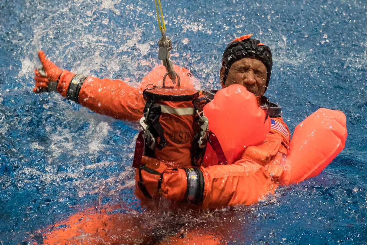 jsc2024e009650 (Jan. 23, 2024) --- NASA astronaut and Artemis II pilot Victor Glover gives teams a thumbs up as he exits a mockup of the Orion spacecraft during a training exercise in the Neutral Buoyancy Lab at NASA’s Johnson Space Center in Houston on Jan. 23. The crew practiced the recovery procedures they will use when the splash down in the Pacific Ocean at the end of their 10-day mission around the Moon next year.