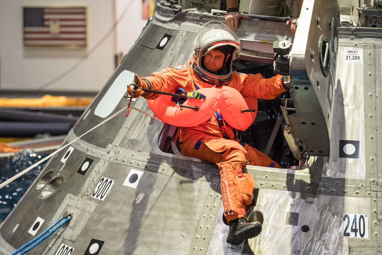 jsc2024e010107 (Jan. 23, 2024) --- NASA astronaut and Artemis II commander Reid Wiseman exits the side of a mockup of the Orion spacecraft during a training exercise in the Neutral Buoyancy Lab at NASA’s Johnson Space Center in Houston on Jan. 23. As part of training for their mission around the Moon next year, the first crewed flight under NASA’s Artemis campaign, the crew practiced the recovery procedures they will use when the splash down in the Pacific Ocean.