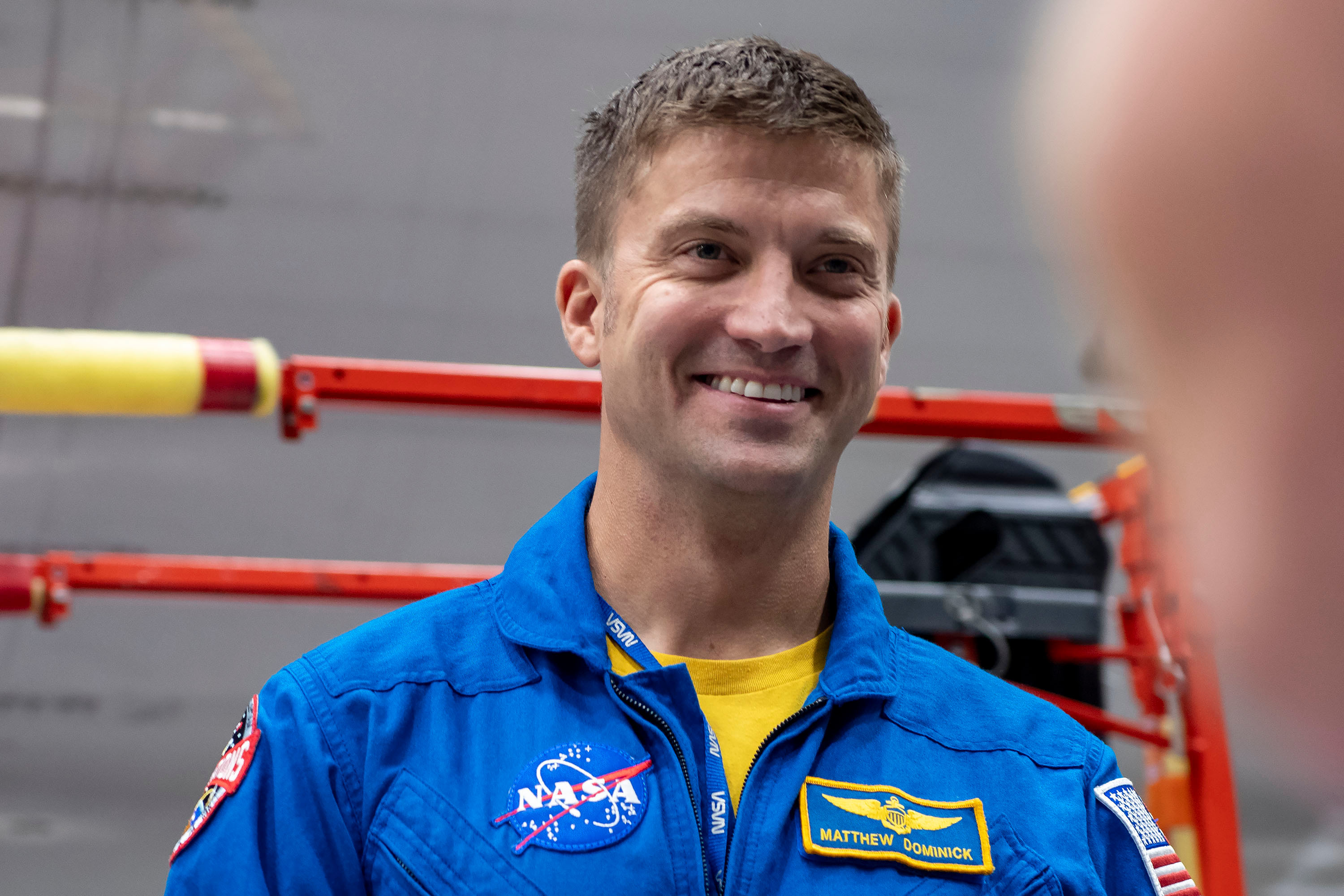 jsc2024e011739 (Oct. 12, 2023) --- SpaceX Crew-8 Commander Matthew Dominick poses for a photo inside SpaceX Hangar X at the Kennedy Space Center in Florida. Hangar X supports Falcon 9 rocket refurbishment and houses administration offices. Credit: SpaceX
