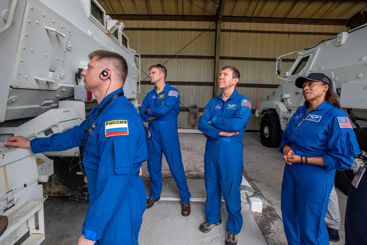 jsc2024e011757 (Oct. 12, 2023) --- The four crew members of NASA's SpaceX Crew-8 mission train outside an emergency egress vehicle at NASA's Kennedy Space Center's Launch Pad 39A in Florida. From left are, Mission Specialist Alexander Grebenkin, Commander Matthew Dominick, Pilot Michael Barratt, and Mission Specialist Jeanette Epps. Astronauts would use the emergency egress vehicle to quickly leave the launch area in the unlikely event of an emergency. Credit: SpaceX