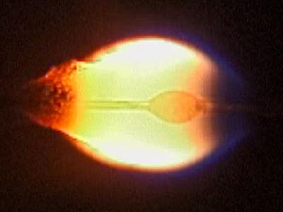 jsc2024e016238 (2/14/2024) --- Flame spreading over wire insulation in microgravity obtained by 10 s drop tower of the Japan Microgravity Center. Uniform low speed air flow is suppled from right to left. Molten PE ball is observed in the flame. Soot particles are continuously emitted at the rear of the flame. Fundamental Research on International Standard of Fire Safety in Space – Base for Safety of Future Manned Missions (FLARE), a Japan Aerospace Exploration Agency (JAXA) investigation, explores the flammability of materials in microgravity. Image courtesy of Hokkaido University.