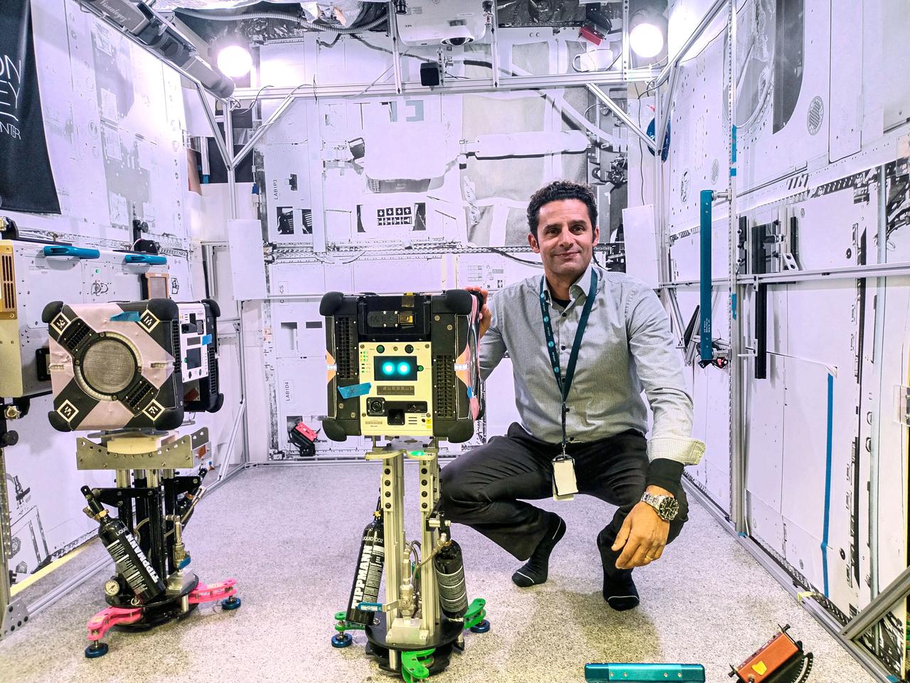 jsc2024e016241 (11/17/2023) --- CSIRO Project Lead Dr. Marc Elmouttie with the Multi-Resolution Scanning payload, housed.within an Astrobee robot. The Multi-Resolution Scanning payload uses multiple different sensor types to generate high-resolution 3D data and more accurate trajectory data to understand how the robot moves around in 3D space. Image courtesy of CSIRO.