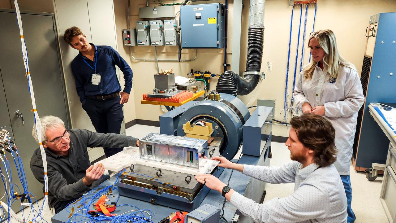 jsc2024e016250 (11/27/2023) --- The Nanoracks-Killick-1 CubeSat is pictured during vibration testing conducted by Canadian Space Agency (CSA) personnel. From left to right – Sylvain Mondor (CSA), Maximilian Brummel (Nanoracks), Anton Sura (CSA), and Victoria Vaters (Engineering Student). Nanoracks-Killick-1 measures sea ice using Global Navigation Satellite System Reflectometry (GNSS-R). Potential applications of GNSS-R include providing data for weather and climate models and improving understanding of ocean phenomena such as surface winds and storm surge. Image courtesy of C-CORE and Memorial University.