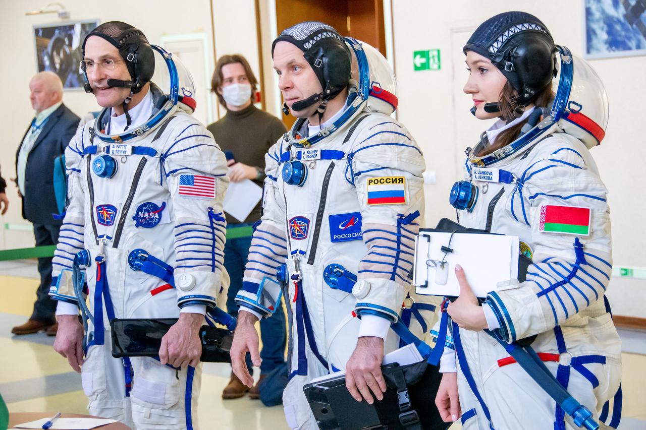jsc2024e016942 (Feb. 28, 2024) --- Soyuz MS-25 backup crew members (from left) Don Pettit from NASA, Ivan Vagner from Roscosmos, and Belarus spaceflight participant Anastasia Lenkova are pictured in their Sokol Launch and entry suits arriving for crew qualification exams at the Gagarin Cosmonaut Training Center in Star City, Russia. Credit: GCTC/Roscosmos