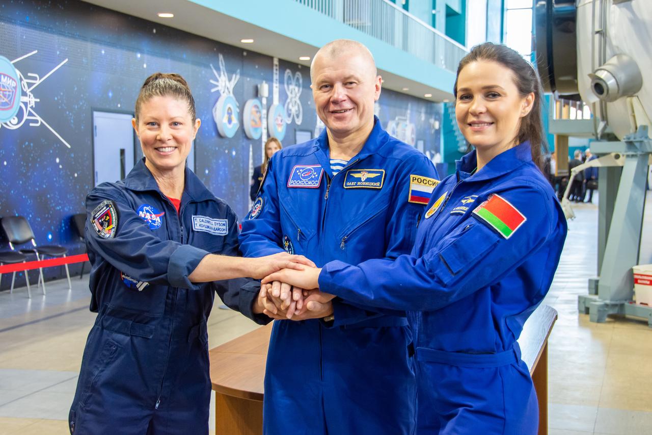 jsc2024e016952 (Feb. 28, 2024) --- Soyuz MS-25 crew members (from left) Tracy Dyson from NASA, Oleg Novitskiy from Roscosmos, and Belarus spaceflight participant Marina Vasilevskaya join hands during their crew qualification exams at the Gagarin Cosmonaut Training Center in Star City, Russia. Credit: GCTC/Roscosmos