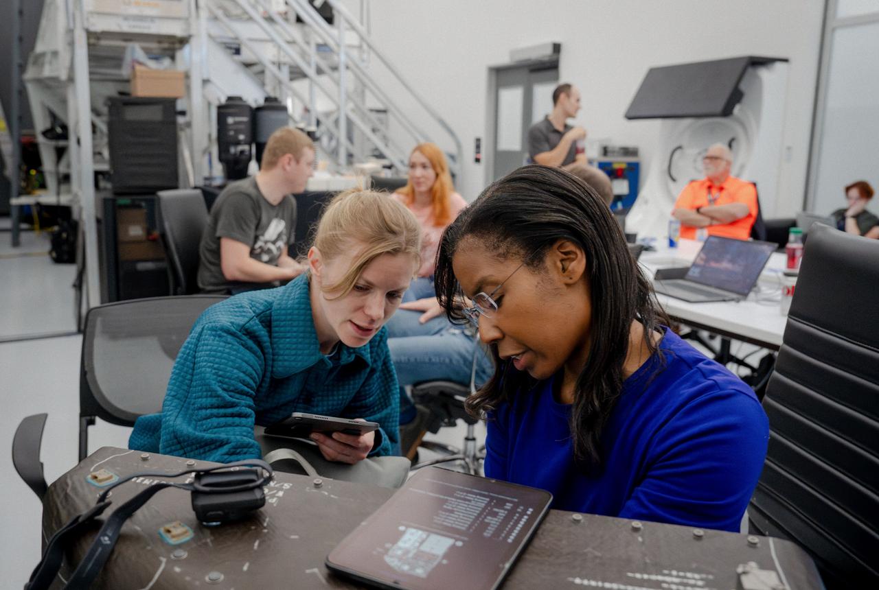 jsc2024e024937 (March 1, 2024) --- NASA’s SpaceX Crew-9 members Commander Zena Cardman and Mission Specialist Stephanie Wilson focus closely on their training, which shows them how to ensure proper weight and balance across the Dragon spacecraft prior to departure and entry. Credit: SpaceX