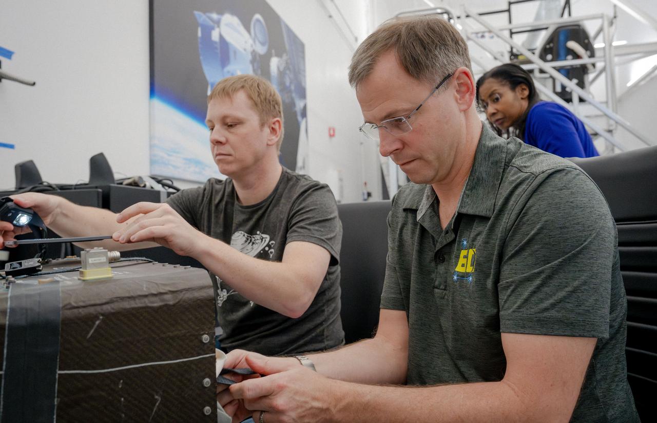 jsc2024e024938 (March 1, 2024) --- NASA’s SpaceX Crew-9 members Mission Specialist Aleksandr Gorbunov and Pilot Nick Hague train on how to properly pack the Dragon spacecraft while Mission Specialist Stephanie Wilson observes at SpaceX headquarters in Hawthorne, California. Credit: SpaceX