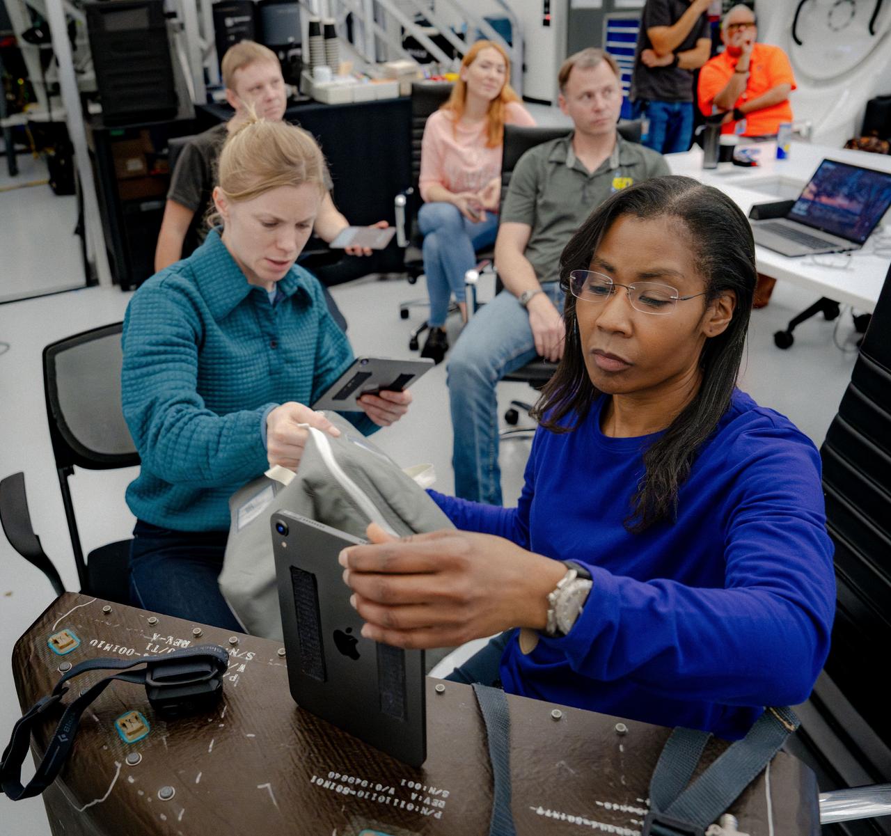 jsc2024e024940 (March 1, 2024) --- NASA’s SpaceX Crew-9 members Commander Zena Cardman and Mission Specialist Stephanie Wilson use a breakout trainer to better understand how to correctly pack the Dragon spacecraft at SpaceX headquarters in Hawthorne, California. Credit: SpaceX