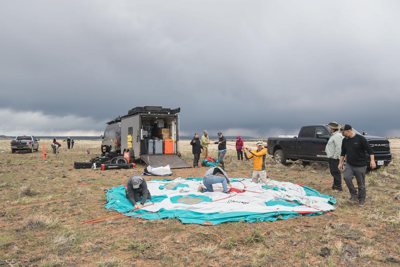 NASA teams work to set up the base camp for the Joint Extravehicular Activity and Human Surface Mobility Test Team Field Test 5 (JETT5) in the San Francisco Volcanic Field in Northern Arizona on May 11, 2024.  Credit: NASA/Josh Valcarcel 