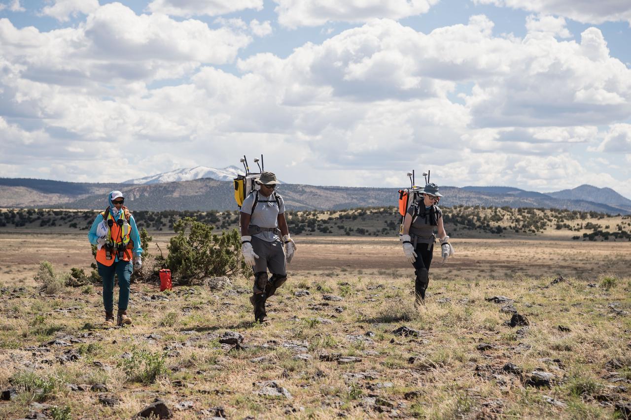 NASA astronauts Andre Douglas (middle) and Kate Rubins (right) walk through the desert during an engineering dry run before the start of a week-long field test consisting of four simulated moonwalks and six advanced technology runs in the San Francisco Volcanic Field in Northern Arizona on May 12, 2024. Image: NASA/Josh Valcarcel