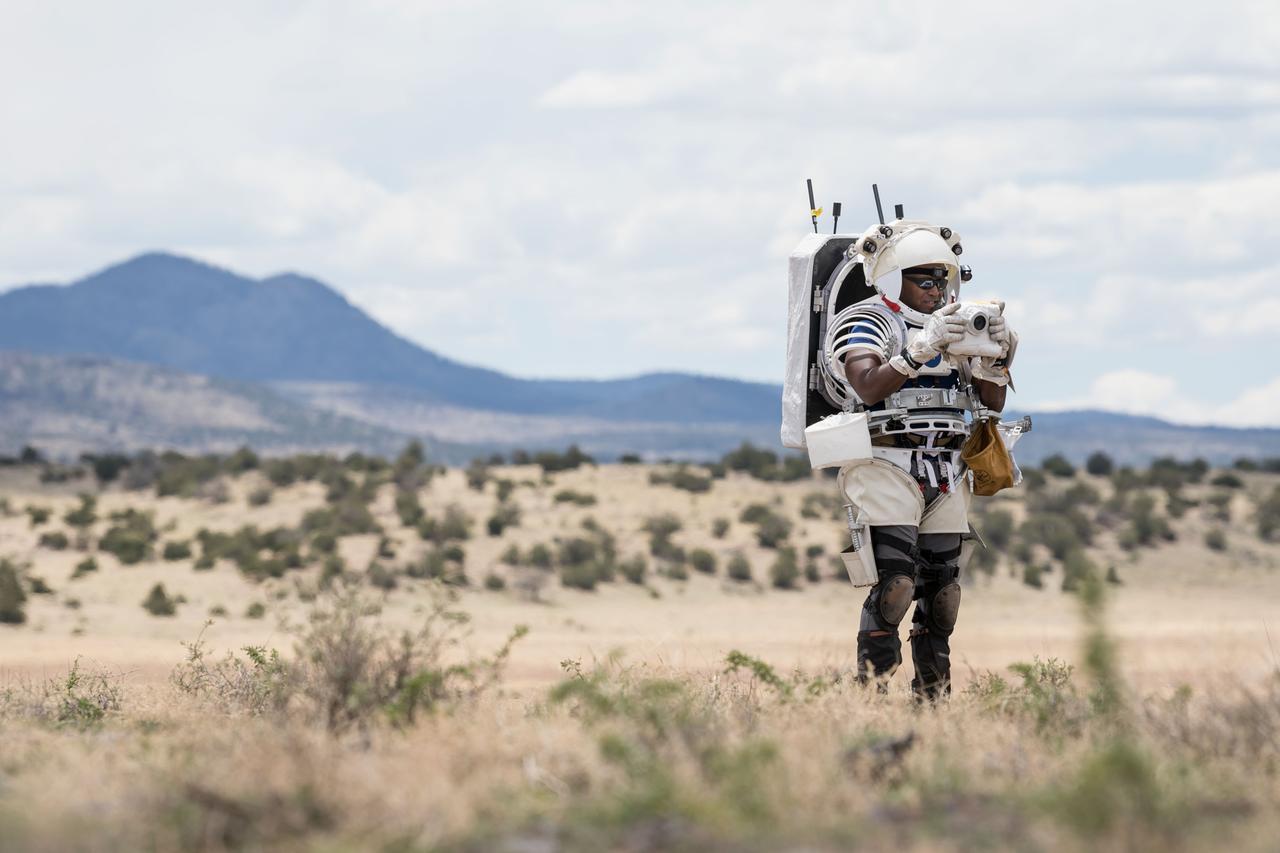 NASA astronaut Andre Douglas takes a picture of the lunar-like landscape during a simulated moonwalk in the San Francisco Volcanic Field in Northern Arizona on May 13, 2024.   Credit: NASA/Josh Valcarcel 