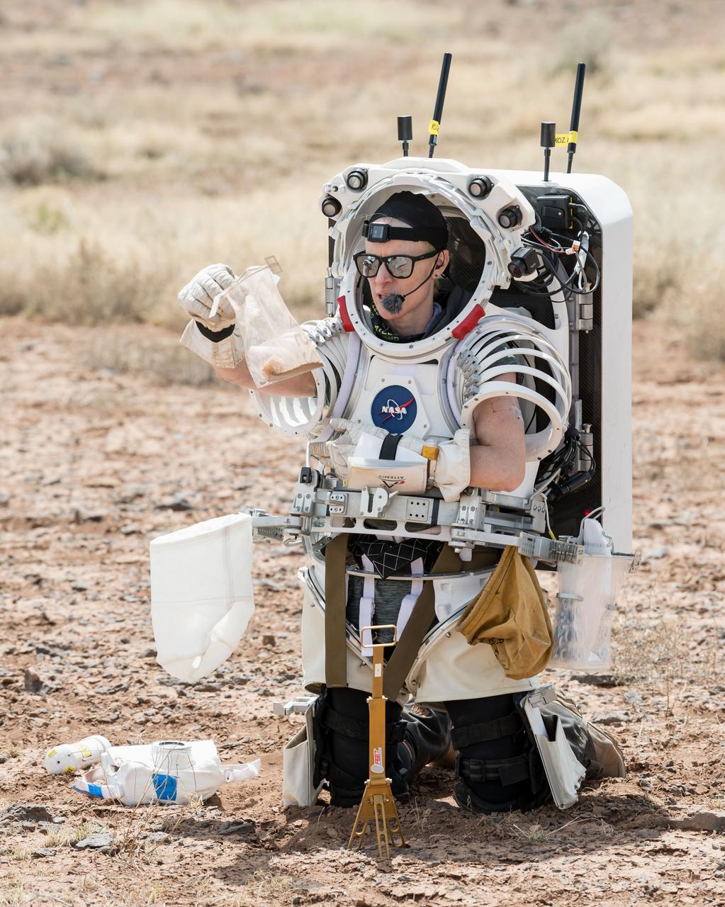 NASA astronaut Kate Rubins examines a geology sample she collected during a simulated moonwalk in the San Francisco Volcanic Field in Northern Arizona on May 13, 2024.   Credit: NASA/Josh Valcarcel 