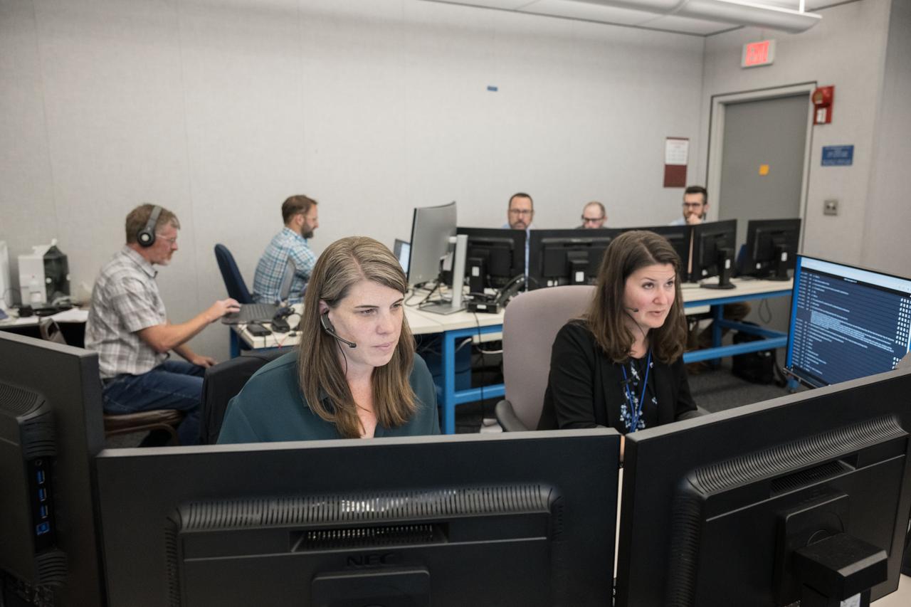 Science Officers Cherie Achilles and Lauren Edgar monitor science operations from a flight control room at NASA’s Johnson Space Center in Houston during a simulated moonwalk field test. JETT 5 was a week-long field test in the lunar-like landscape of San Francisco Volcanic Field near Flagstaff, Arizona while a team of flight controllers and scientists at Johnson monitor and guide their activities. ¬¬ Credit:  NASA/Robert Markowitz