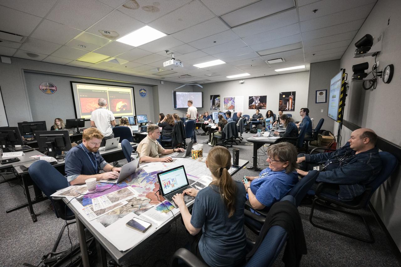 A large group of scientists work in the Science Evaluation Room (SER) at NASA’s Johnson Space Center in Houston during the JETT 5 field test. The SER is the science backroom to mission control during Artemis operations. JETT 5 was a week-long field test in the lunar-like landscape of San Francisco Volcanic Field near Flagstaff, Arizona while a team of flight controllers and scientists at Johnson monitor and guide their activities. Credit: NASA/Robert Markowitz