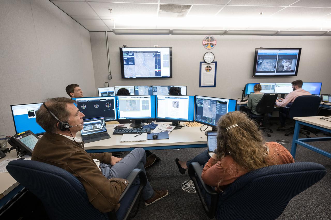 Flight Director Zebulon Scoville, left, and team monitor the JETT 5 extravehicular activities from a mock Mission Control at NASA’s Johnson Space Center in Houston. JETT 5 was a week-long field test in the lunar-like landscape of San Francisco Volcanic Field near Flagstaff, Arizona while a team of flight controllers and scientists at Johnson monitor and guide their activities.   Credit:  NASA/Robert Markowitz