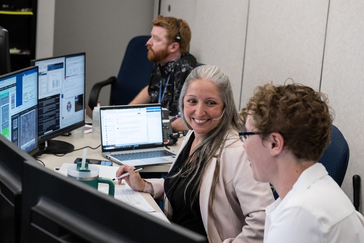 Extravehicular flight controller Jaclyn Kagey, left, and Tess Caswell work in the JETT 5 flight control room during the JETT 5 field test. JETT 5 was a week-long field test in the lunar-like landscape of San Francisco Volcanic Field near Flagstaff, Arizona while a team of flight controllers and scientists at Johnson monitor and guide their activities. Credit NASA/James Blair