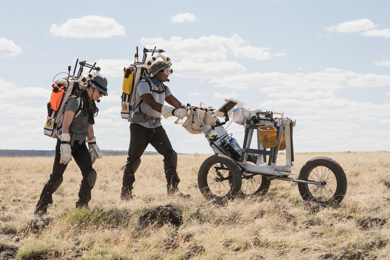 NASA astronauts Kate Rubins and Andre Douglas walk through the lunar-like landscape during a simulated moonwalk in the San Francisco Volcanic Field in Northern Arizona on May 17, 2024. Credit: NASA/Josh Valcarcel 