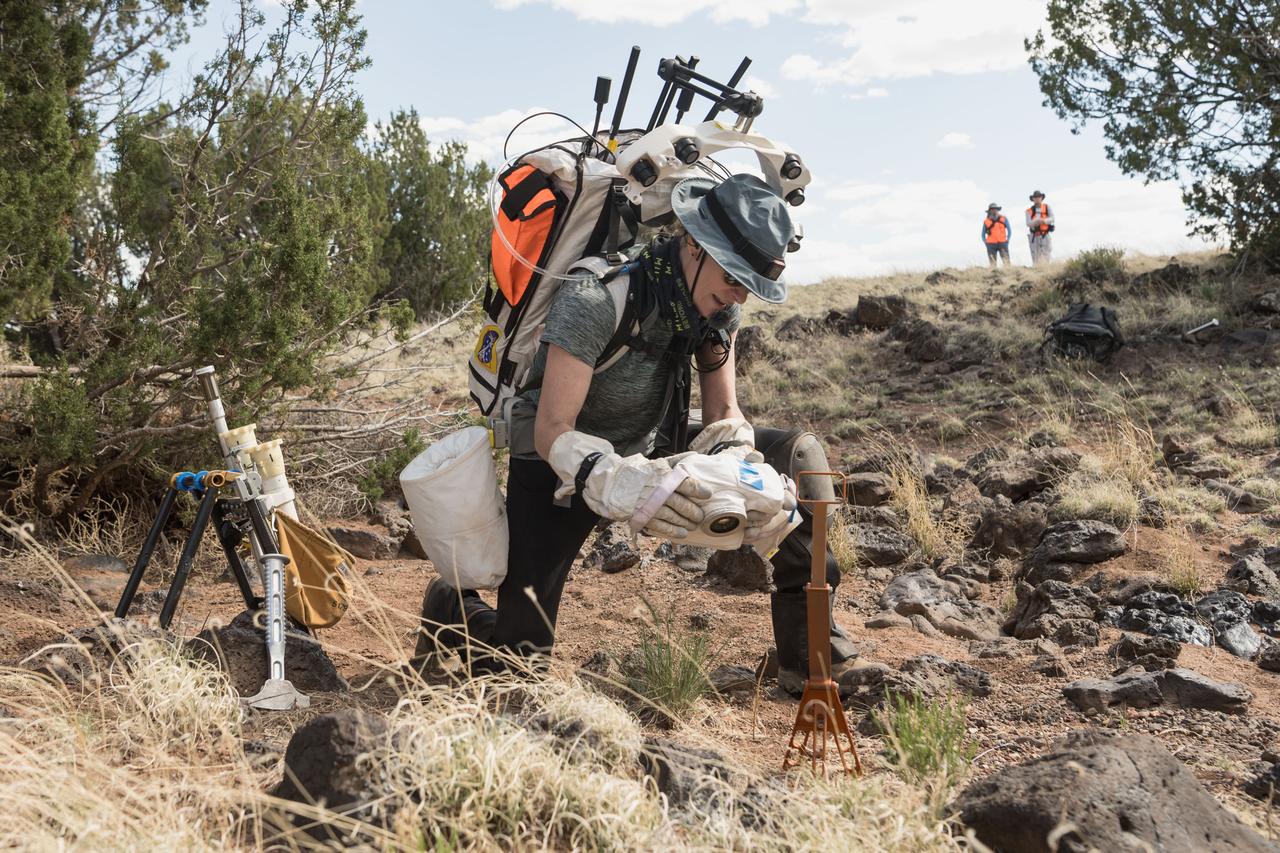 NASA astronaut Kate Rubins takes a picture of a geologic sample during a simulated moonwalk in the San Francisco Volcanic Field in Northern Arizona on May 17, 2024. Credit: NASA/Josh Valcarcel 