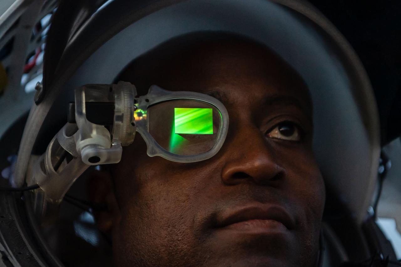 NASA astronaut Andre Douglas wears AR (Augmented Reality) display technology during an advanced technology run in the San Francisco Volcanic Field in Northern Arizona on May 21, 2024. The monocular lens consists of a pico-projector and waveguide optical element to focus an image for crew to see their real world overlaid with digital information. These unique near-eye form factors may be used to improve the usability and minimally impact the complex biomechanics of working in a pressurized suit environment. Credit: NASA/Josh Valcarcel 